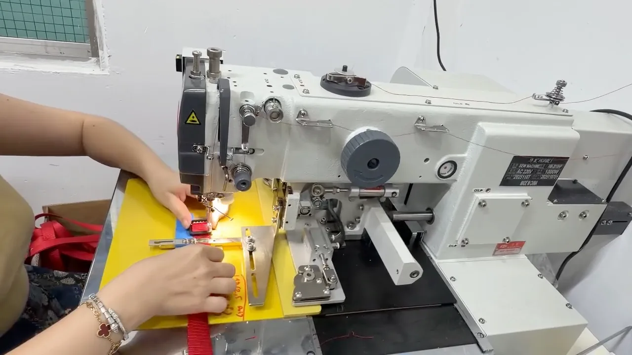 Sewing red webbing on an industrial machine at the Viepex pet gear workshop in Vietnam